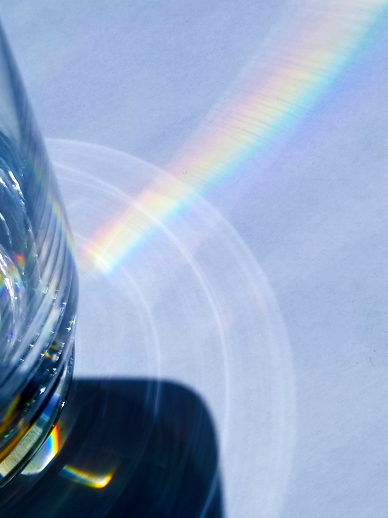 Prism separating light into rainbow